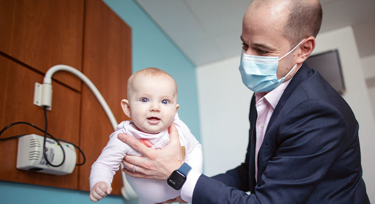 Image of doctor holding baby